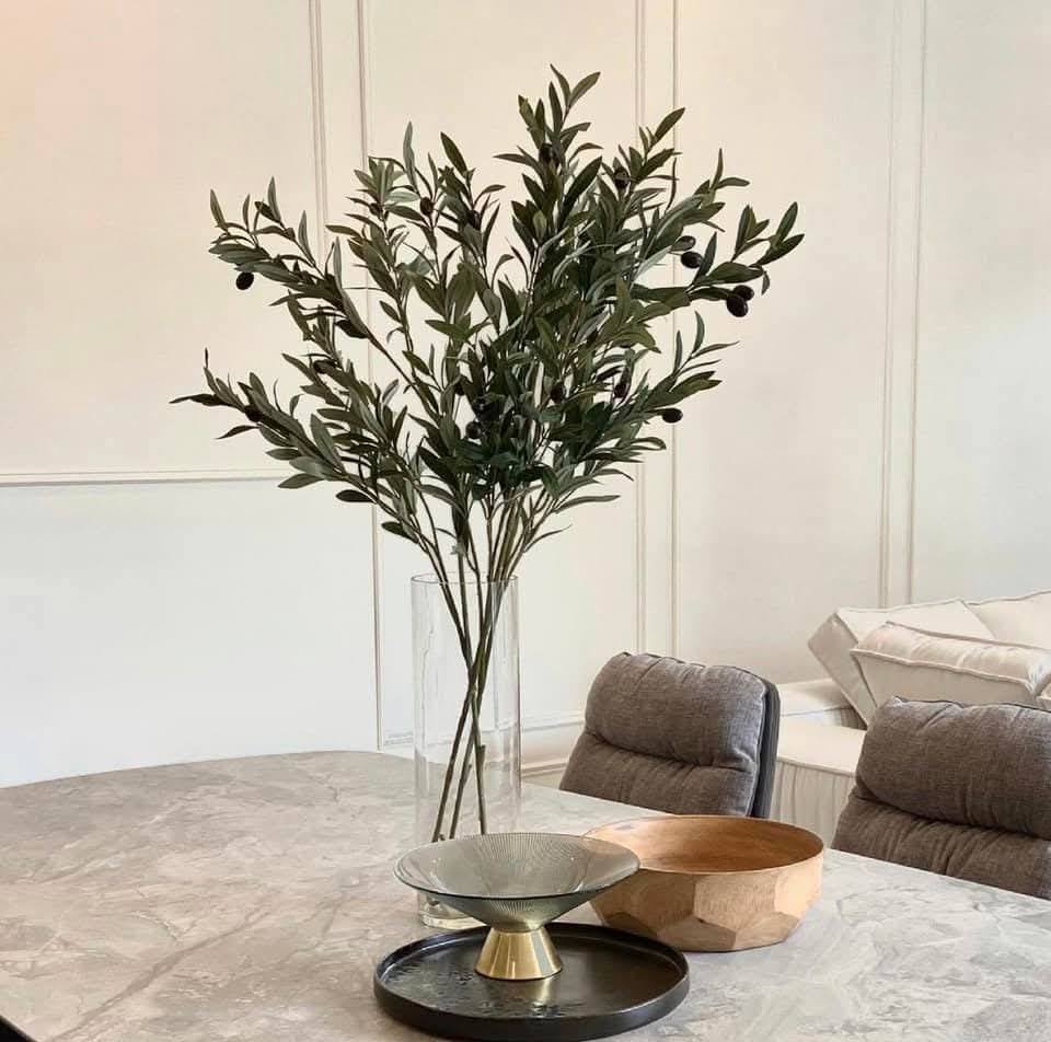 Olive branch still life on marble dining table